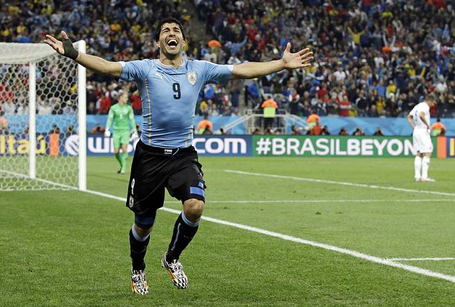 Uruguay's Luis Suarez celebrates after scoring his side's second goal during the group D World Cup soccer match between Uruguay and England at the Itaquerao Stadium in Sao Paulo, Brazil, Thursday, June 19, 2014. 