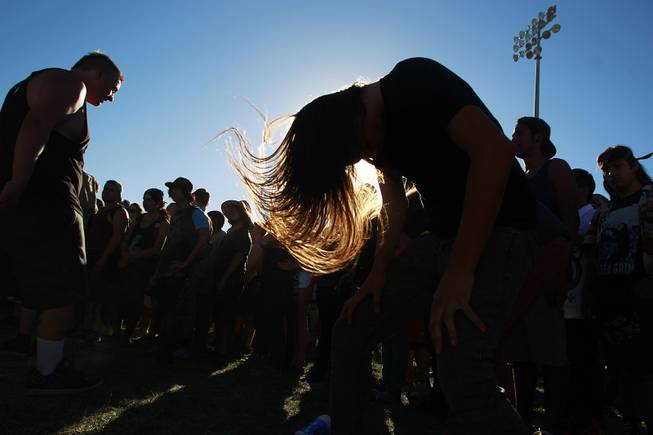 Fans headbang to the band Born of Osiris during the Las Vegas stop of the Vans Warped Tour Thursday, June 19, 2014.
