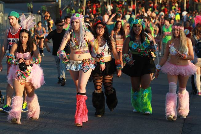 Festival goers make their way in to the Las Vegas Motor Speedway during the first night of the Electric Daisy Carnival Friday, June 20, 2014.
