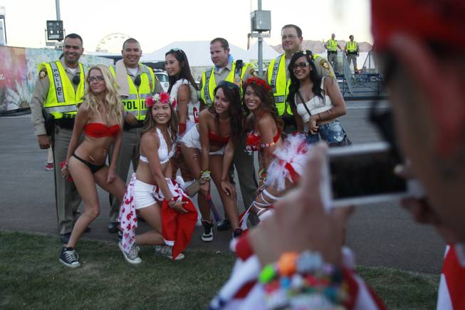 Metro officers pose for a photo with attendees during the first night of the Electric Daisy Carnival Friday, June 20, 2014 at the Las Vegas Motor Speedway.