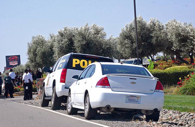 Vehicles marked "Tribal Police" and uniformed personnel post themselves at the parking lot entrances of the Rolling Hills Casino in an attempt to shut down its operations in Corning, Calif., Monday, June 9, 2014. The Northern California Native American casino is at the center of a tense tribal dispute. 