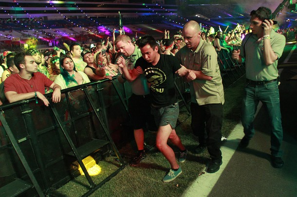 An inebriated attendee is helped out of a venue during the first night of the Electric Daisy Carnival Saturday, June 21, 2014 at the Las Vegas Motor Speedway.
