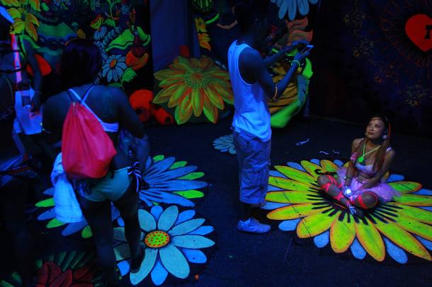 Attendees explore a black light, 3D installation during the first night of the Electric Daisy Carnival Saturday, June 21, 2014 at the Las Vegas Motor Speedway.