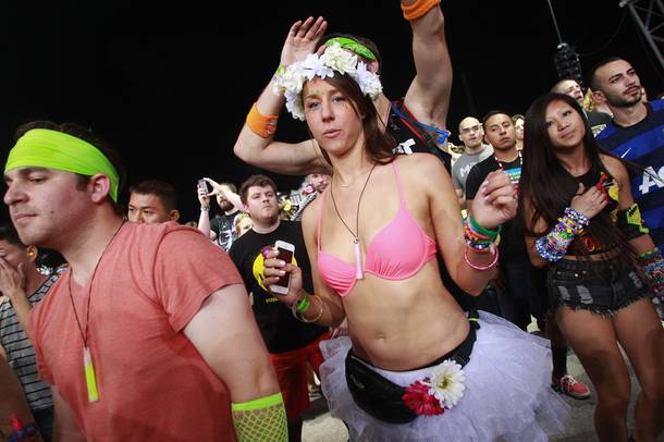 People dance during the first night of the Electric Daisy Carnival Saturday, June 21, 2014 at the Las Vegas Motor Speedway.