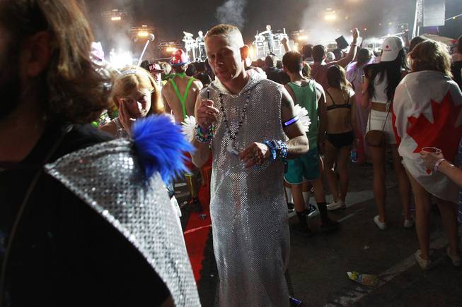 People mill about at the Neon Garden stage during the first night of the Electric Daisy Carnival Saturday, June 21, 2014 at the Las Vegas Motor Speedway.