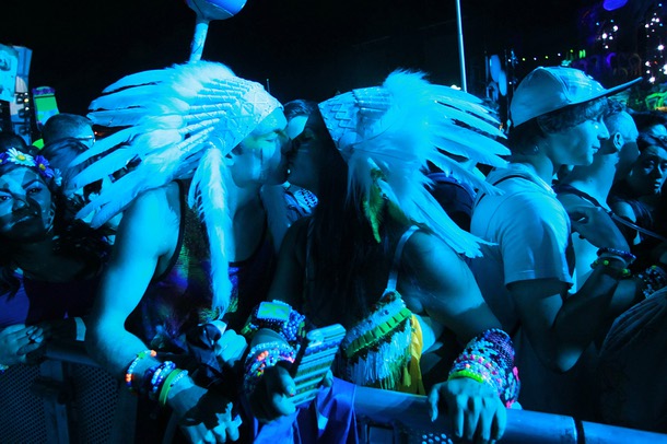 A couple in native american headdresses kiss during the first night of the Electric Daisy Carnival early Saturday, June 21, 2014 at the Las Vegas Motor Speedway.