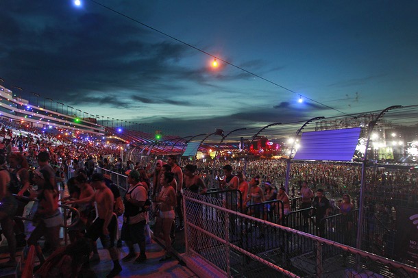 As the sun begins to rise, attendees begin heading for the exits during the first night of the Electric Daisy Carnival early Saturday, June 21, 2014 at the Las Vegas Motor Speedway.