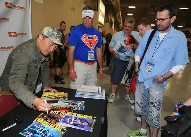 Comic book artist Jim Lee autographs items for fans during the first day of Las Vegas Comic Con 2014 at the South Point Convention Center on Saturday, June 21, 2014.