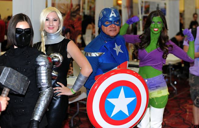Fans of comic book heroes and villains pose in costume for photographs during the first day of the Las Vegas Comic Con at the South Point Convention Center on Saturday, June 21, 2014.