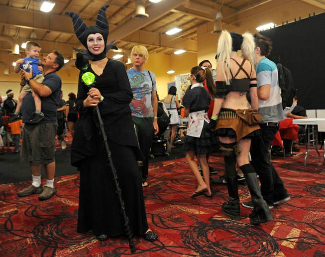 Devany Del Padre, left, poses as the Disney villain Maleficent during the first day of Las Vegas Comic Con at the South Point Convention Center on Saturday, June 21, 2014.