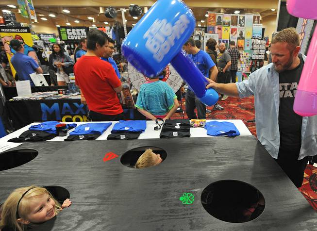 The Davidson family plays "Whack-a-nerd" during the first day of the Las Vegas Comic Con at the South Point Convention Center on Saturday, June 21, 2014.
