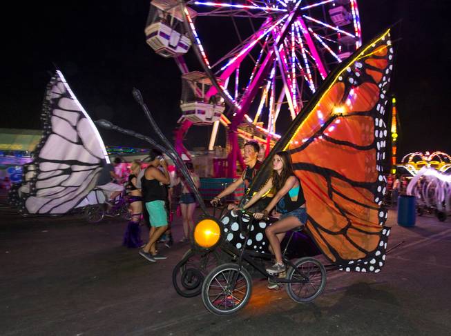 Butterfly bicycles are pedaled along the concourse during opening night of EDC at the Las Vegas Motor Speedway on Friday, June 20, 2014.