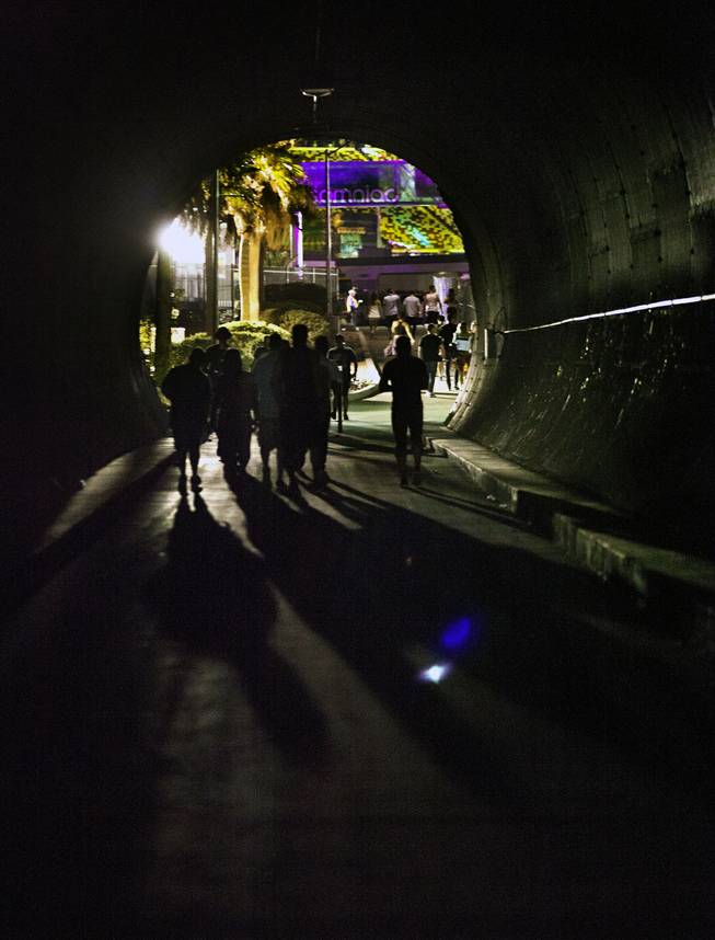Attendees walk through the tunnel to enter opening night of EDC at the Las Vegas Motor Speedway on Friday, June 20, 2014.