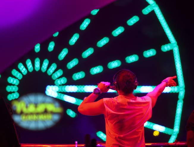A DJ pumps up the crowd during opening night of EDC at the Las Vegas Motor Speedway on Friday, June 20, 2014.