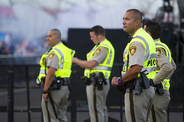 Metro Police Officer Rico Rodriguez, right, keeps watches music fans during the final day of the 2014 Electric Daisy Carnival (EDC) at the Las Vegas Motor Speedway Sunday, June 22, 2014.