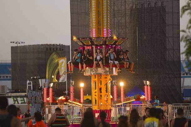 Music fans take a carnival ride during the final day of the 2014 Electric Daisy Carnival (EDC) at the Las Vegas Motor Speedway Sunday, June 22, 2014.