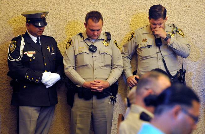 Las Vegas police bow their heads during a memorial service for Joseph Wilcox at Palm Downtown Mortuary and Cemetery on Sunday, June 22, 2014. Wilcox, 31, was killed trying to stop Jerad and Amanda Miller in the midst of their shooting spree at an east valley Walmart store on June 8.