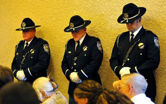 Members of the Nevada Highway Patrol Honor Guard bow their heads during a memorial service for Joseph Wilcox at Palm Downtown Mortuary and Cemetery on Sunday, June 22, 2014. Wilcox, 31, was killed trying to stop Jerad and Amanda Miller in the midst of their shooting spree at an east valley Walmart store on June 8.