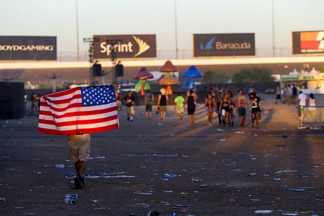 A fan heads to an exit after the final night of the 2014 Electric Daisy Carnival (EDC) at the Las Vegas Motor Speedway Sunday, June 22, 2014.