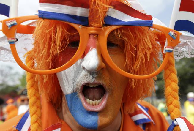 A Dutch fan cheers for his national team before the group B World Cup soccer match between the Netherlands and Chile at the Itaquerao Stadium in Sao Paulo, Brazil, Monday, June 23, 2014. 