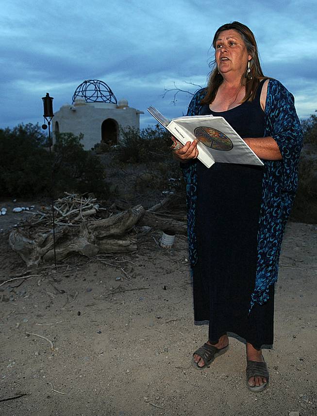 Priestess Canace Ross addresses a small gathering of people outside a temple in the desert near Indian Springs before hosting a Litha ceremony, a Wiccan tradition honoring the summer solstice on Saturday evening.