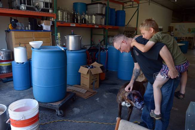 Marine Corps veteran Andy Kulakowski pets Socks at Uncle Sam&apos;s Misguided Brewery, with his son Mason Kulakowski hanging on in Livermore, Calif., on Monday, May 26, 2014. Free tastings were part of the brewery and winery&apos;s Memorial Day event for all veterans.