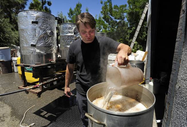 Army veteran Eric Johnson, of Fremont, Calif., pours hot water into the mash of Valor Double IPA at Uncle Sam&apos;s Misguided Brewery in Livermore, Calif., on Monday, May 26, 2014. The brewery is run by fellow veterans and co-owners Josh Laine and Fara Eve Barnes.