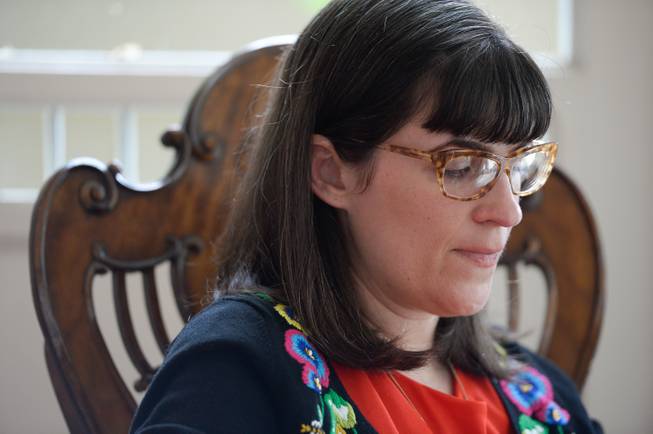 Kate Kelly, founder of Ordain Women, checks messages of support and requests for interviews during a quiet moment at a bed and breakfast near the Church of Jesus Christ of Latter-day Saints in Salt Lake City after getting an official message through email that she had been excommunicated, Monday, June 23, 2014.