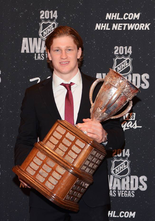 Nathan MacKinnon of the Colorado Avalanche with the Calder Memorial Trophy at the 2014 NHL Awards in Encore Theater on Tuesday, June 24, 2014, at Wynn Las Vegas.