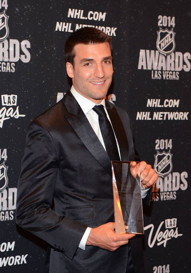 Patrice Bergeron of the Boston Bruins with the NHL Foundation Award at the 2014 NHL Awards in Encore Theater on Tuesday, June 24, 2014, at Wynn Las Vegas.