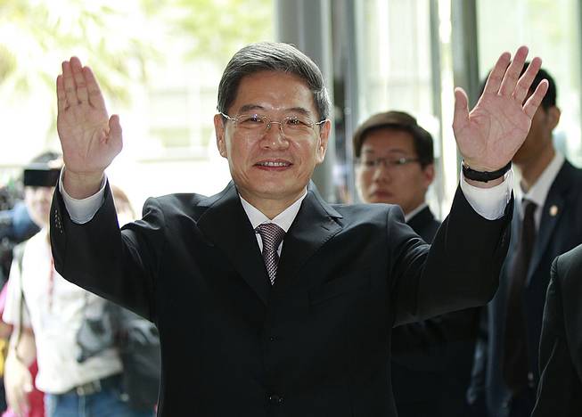 Zhang Zhijun, minister of Beijing’s Taiwan Affairs Office, waves at the airport hotel upon arrival in Taoyuan, Taiwan, Wednesday, June 25, 2014. 