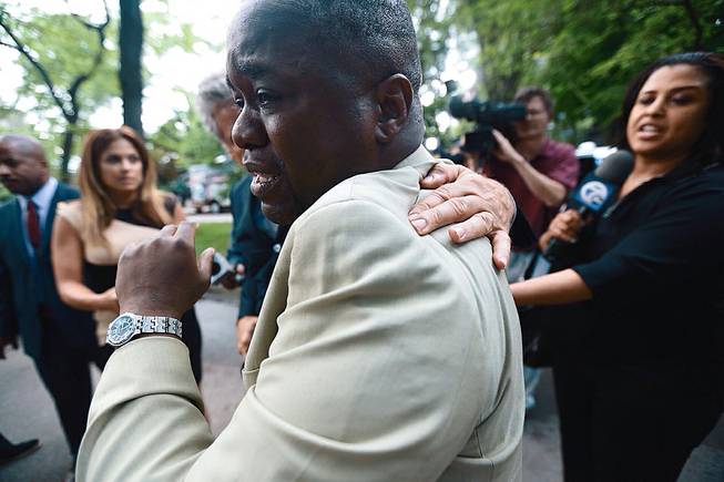 Charlie Bothuell IV becomes emotional after arriving home after the Detroit Police Department found his missing 12-year old son Charlie Bothuell V in the basement of his home in Detroit on Wednesday, June 25, 2014. 