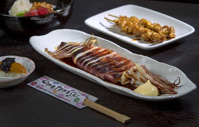 Grilled Squid is shown at Izakaya Cocokala, 4449 W. Flamingo Road, Thursday, June 26, 2014. Also pictured are Bakudan, top left, Sea Urchin Spoon Rice, left, and Chicken Skin Skewers with sauce.