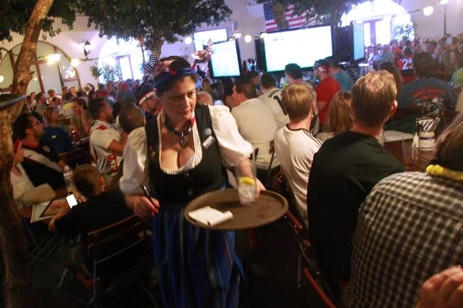 A waitress makes her way through the crowds at the Hofbrauhaus as the United States takes on Germany in their Group G game at the World Cup in Brazil Thursday, June 26, 2014.