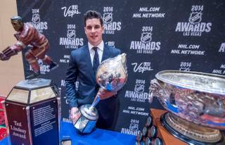 Sidney Crosby of the Pittsburgh Penguins with his Ted Lindsay, Art Ross and Hart Memorial trophies at the 2014 NHL Awards in Encore Theater on Tuesday, June 24, 2014, at Wynn Las Vegas.