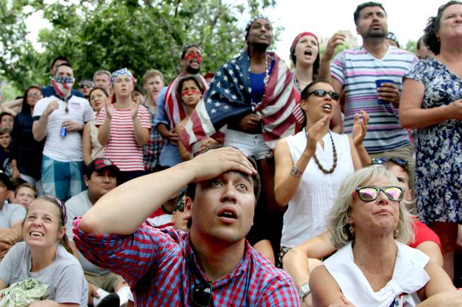 Jack Cooper, 24, center, of Washington, and others, react while watching the US-Germany World Cup soccer match, Thursday, June 26 2014, during a viewing party sponsored by the German Embassy at Dupont Circle in Washington. 