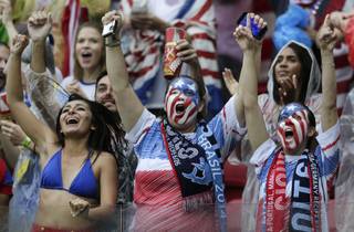 US fans celebrate after their team advanced to the round of 16 despite losing 0-1 to Germany during the group G World Cup soccer match between the USA and Germany at the Arena Pernambuco in Recife, Brazil, Thursday, June 26, 2014. 