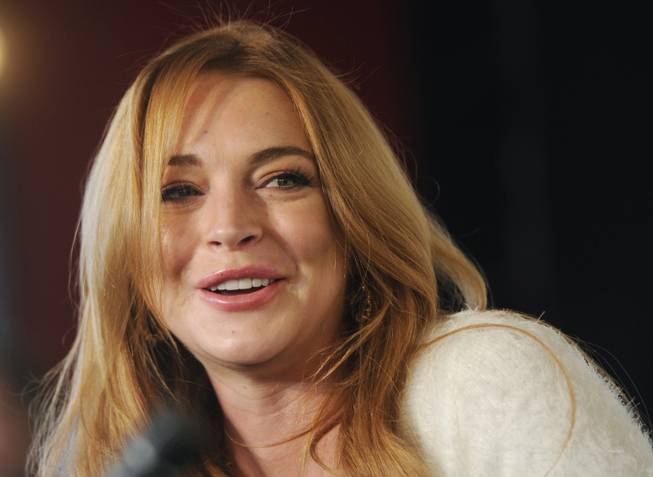 In this Jan. 20, 2014, photo, actress Lindsay Lohan addresses reporters during a news conference at the 2014 Sundance Film Festival in Park City, Utah. Lohan is suing the makers of "Grand Theft Auto." The actress says the latest video game installment used her image and created a character based on her without her permission. 