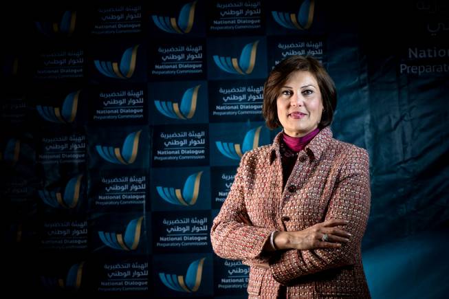 In this March 2014 image released by the National Dialogue Preparatory Commission, Salwa Bugaighis, lawyer and rights activist, poses for a photograph during a meeting in Tripoli, Libya.