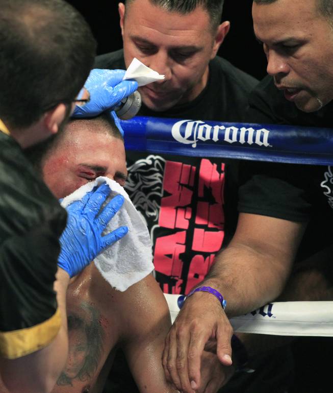 Pennsylvania's Ronald Cruz has a cut over his eye attended to by his cornerman as ShoBox: The New Generation on SHOWTIME presents their welterweight fight at the Hard Rock Hotel & Casino on Friday, June 27, 2014.