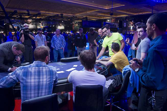 Players select their seats before the start of the Big One for One Drop, a $1,000,000 buy-in No-Limit Hold'em charity poker tournament, at the Rio Sunday, June 26, 2014. The $1 million buy-in is the largest ever for a poker event. Proceeds support One Drop projects in countries experiencing serious difficulties caused by inadequate access to water.