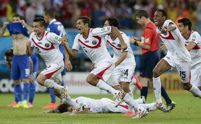 Costa Rica players react after Michael Umana scores during a shootout after regulation time in the World Cup round of 16 soccer match between Costa Rica and Greece at the Arena Pernambuco in Recife, Brazil, on Sunday, June 29, 2014. Costa Rica defeated Greece 5-3 in penalty shootouts after a 1-1 tie.