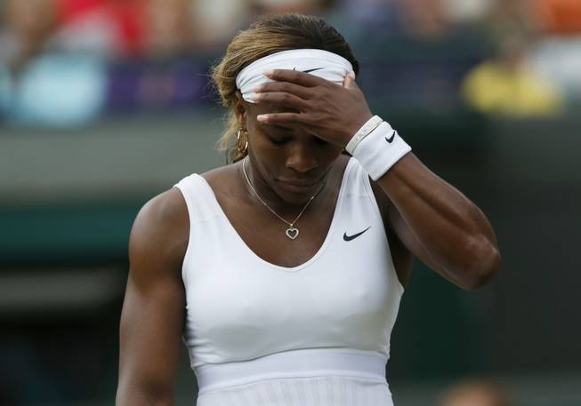 Serena Williams of the U.S. gestures after losing a point to Alize Cornet of France during their women's singles match at the All England Lawn Tennis Championships in Wimbledon, London, Saturday, June 28, 2014.