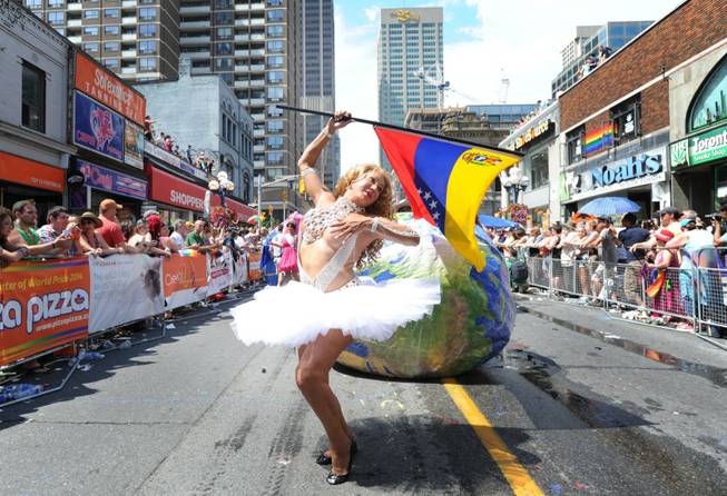 Parade goers celebrate during the WorldPride Parade in Toronto, Sunday, June 29, 2014. The parade, which is the culmination of WorldPride 2014, attracts over a million people.