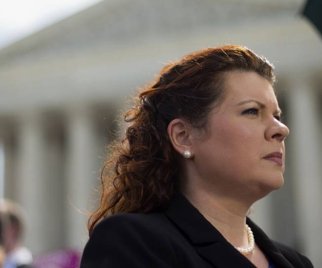 Lori Windham, the attorney representing Hobby Lobby, stands outside the Supreme Court in Washington, Monday, June 30, 2014, following the decision on the Hobby Lobby case. The Supreme Court says corporations can hold religious objections that allow them to opt out of the new health law requirement that they cover contraceptives for women. 