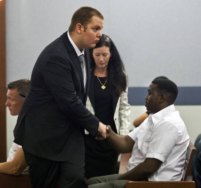 Jim Edward Johnson, who told police he accidentally shot his friend while filming a rap video at the Palms, shakes a man's hand after appearing in Justice Court for a prelim hearing on Tuesday, July 1, 2014.  L.E. Baskow