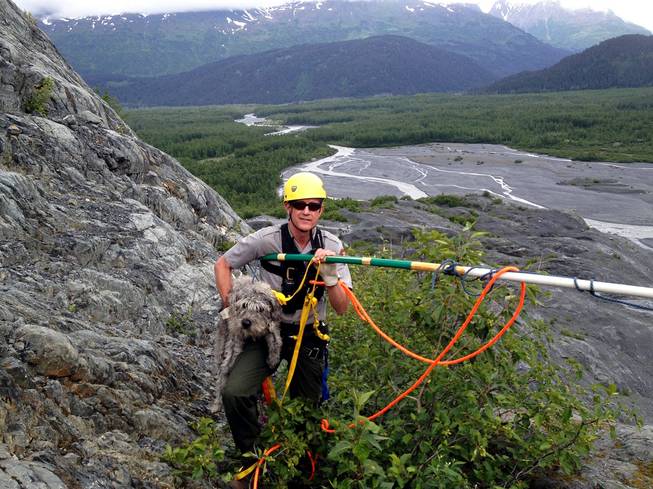 Kenai Fjords National Park Ranger John Anderson is shown with Sadie after her rescue from a ledge near a glacier on Monday, June 30, 2014, at Kenai Fjords National Park, Alaska. 