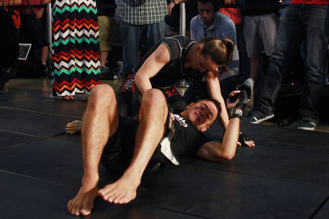 Alexis Davis grapples with Flavio Meier during the open workout for UFC 175 Wednesday, July 2, 2014 at the Fashion Show Mall.