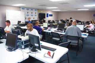 Local downtown residents works on projects, such as, resume development and job searching, at The Larson Training Center, a community learning facility located downtown, Wednesday July 1, 2014.