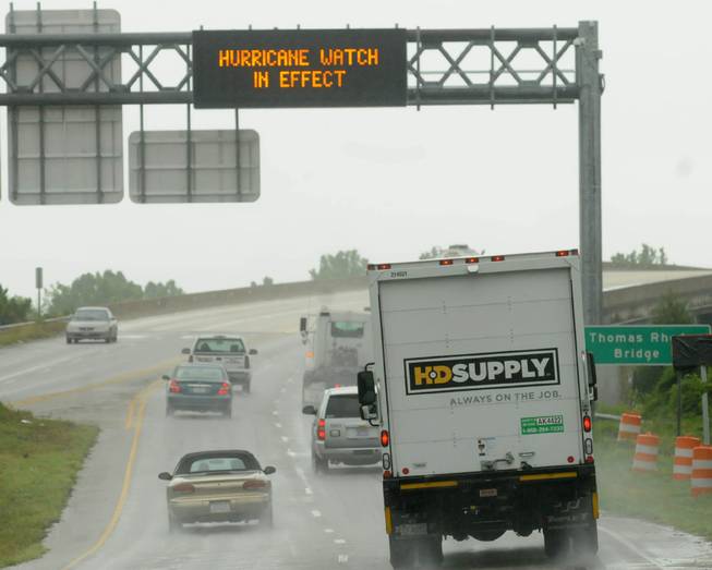 Vehicles travel across the Thomas Rhodes Bridge as rain falls early Thursday morning, July 3, 2014, in Wilmington, N.C. Residents along the coast of North Carolina are bracing for the arrival of the Hurricane Arthur, a category one storm.